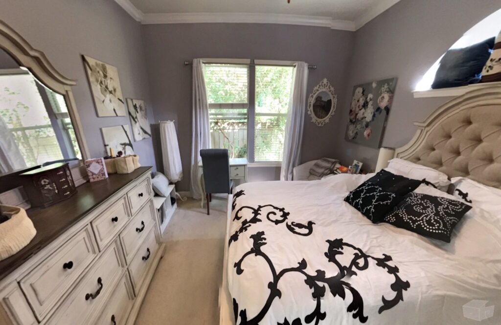 One of three bedrooms in the home, with natural light and neutral carpet.
