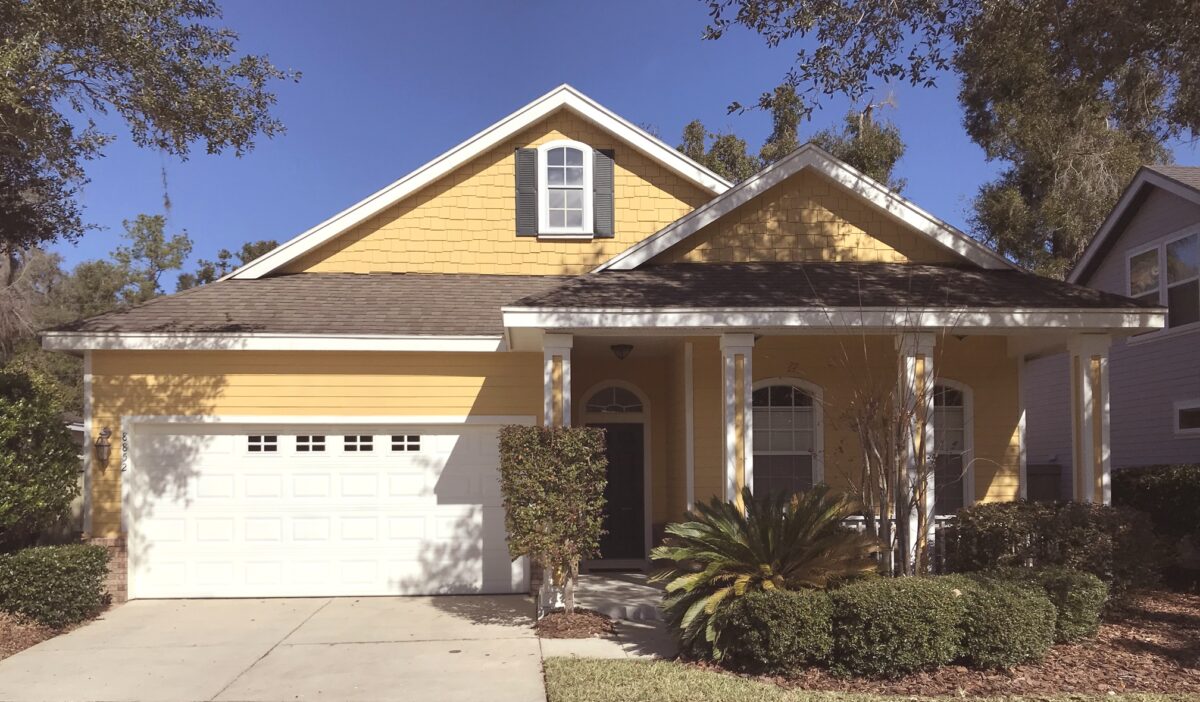 Front exterior of the two-story home at 8852 SW 25th Rd, with a paved driveway and two-car garage.