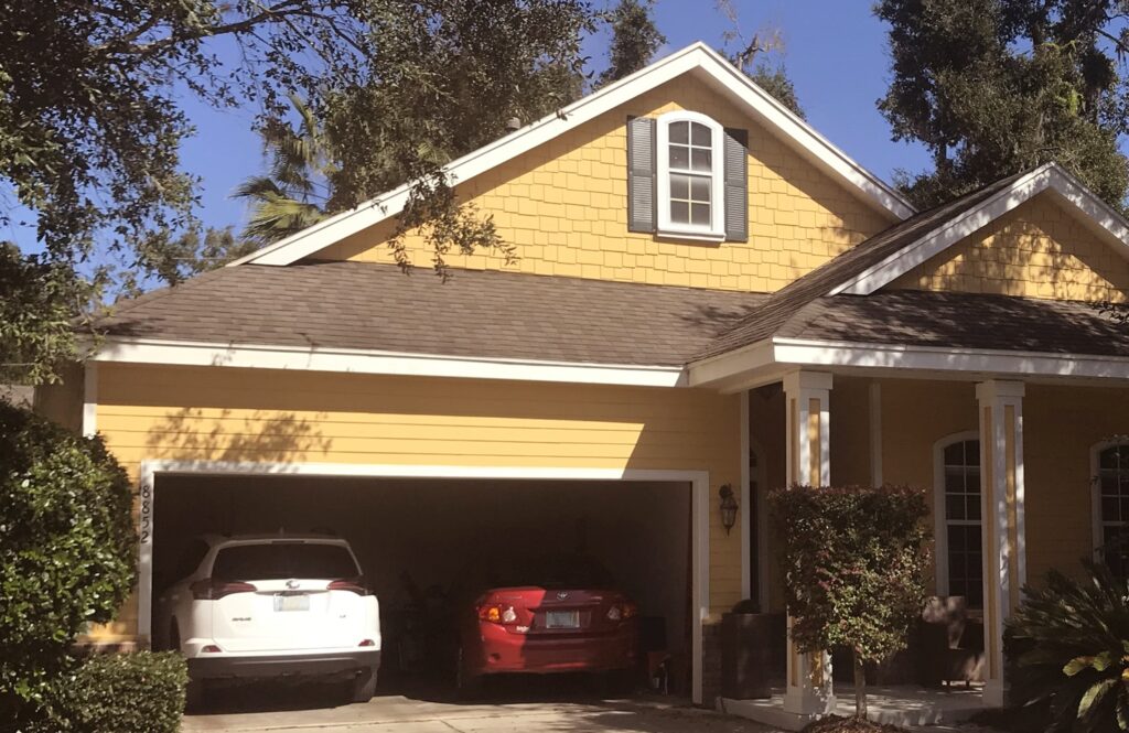 Two-car garage with epoxy flooring and storage space.