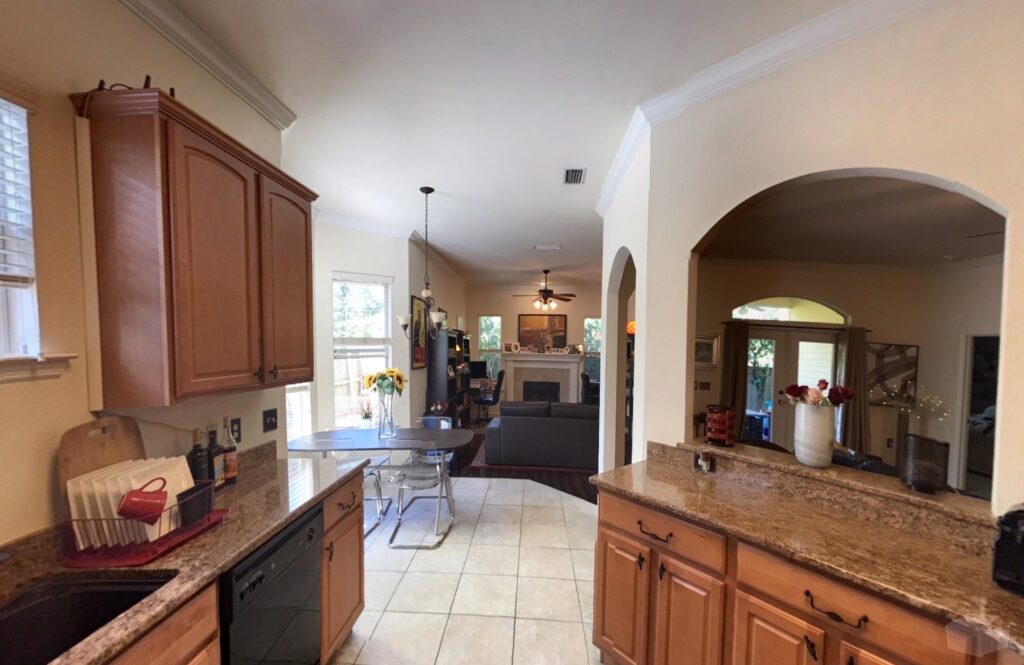 Kitchen with granite countertops, wood cabinetry, and stainless steel appliances.